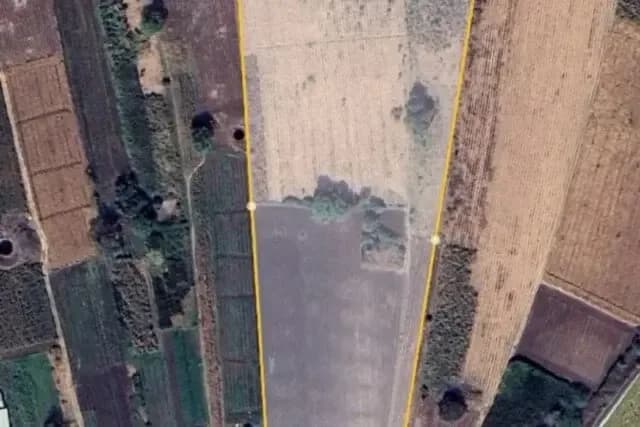 Aerial view of the farmland plot with its boundary marked in yellow